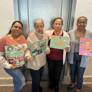 Support group participants displaying collages they made