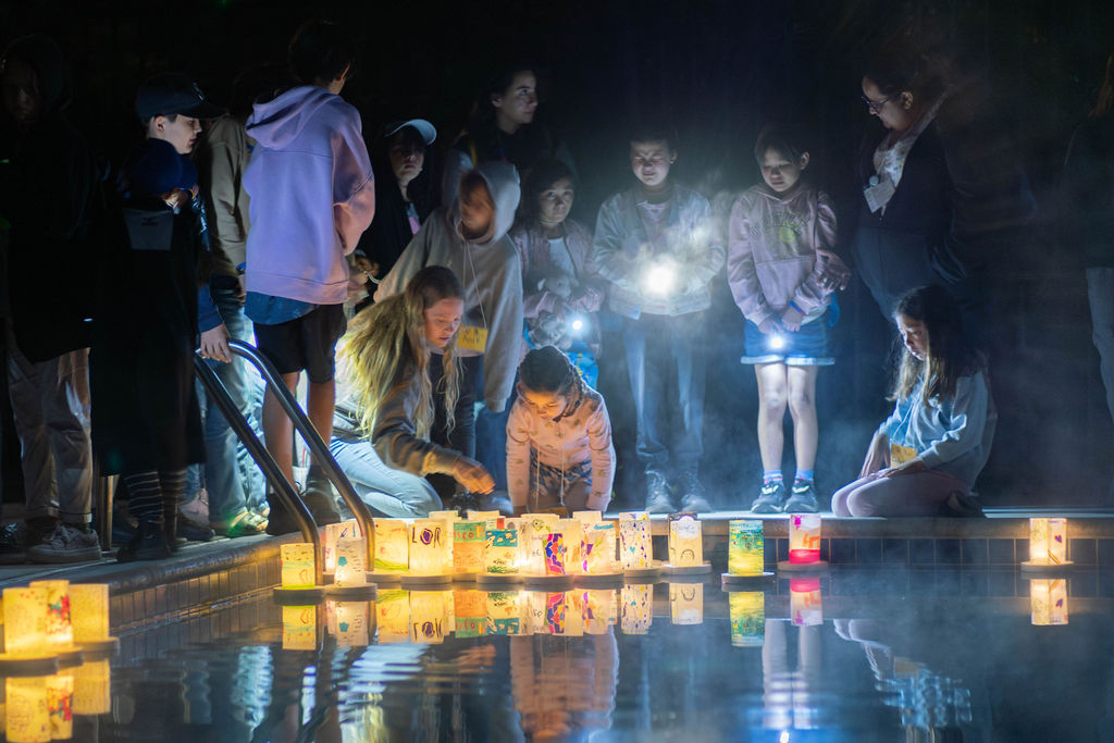 children setting luminaries afloat as part of a Camp Erin ceremony