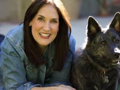 Photo of Besty Lautman lounging with her dog