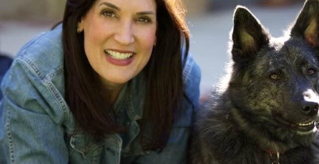 Photo of Besty Lautman lounging with her dog